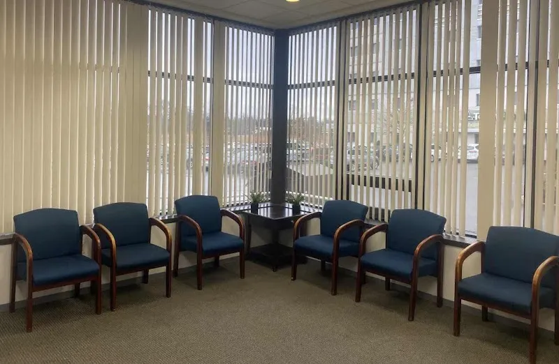 Bright waiting area with blue chairs at Middlesex Recovery PC, a detox center in Boston.