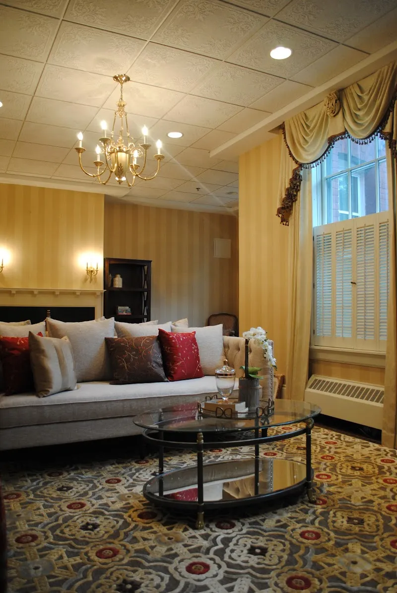 Cozy living room with chandelier at Washburn House detox center in Boston.