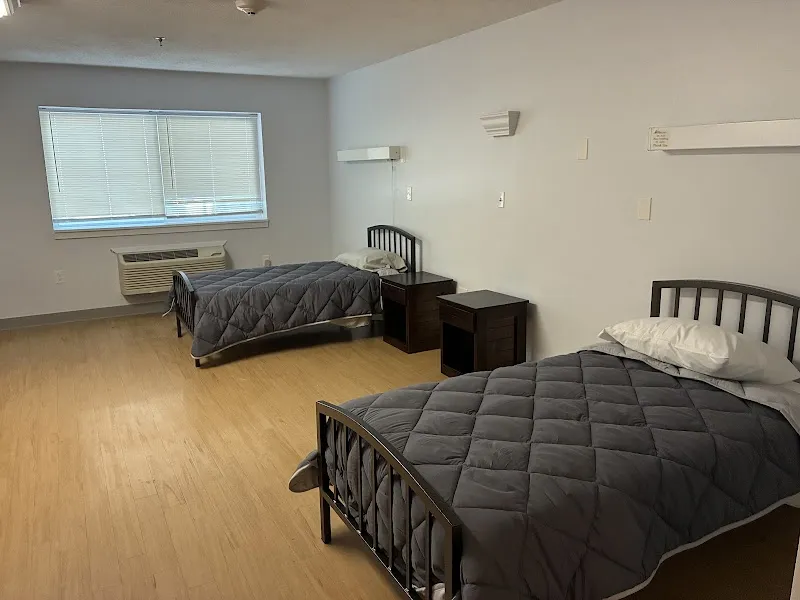 Cozy bedroom with two beds at Pyramid Healthcare Boston Metro Detox and Residential Treatment Center, detox center in Boston.