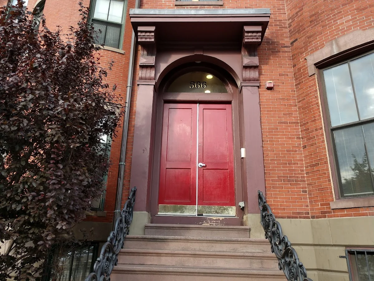 Red double doors of Victory House, an intensive outpatient program in Boston, welcoming clients to recovery.