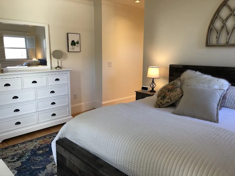 Cozy bedroom with plush bedding at The Harbor House, a sober living home in Boston.