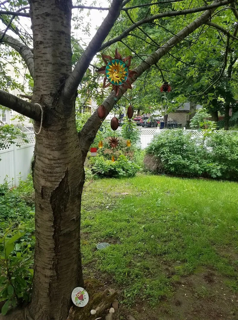 Lush green backyard with decorative ornaments at Boston Sober Homes, a sober living home in Boston.