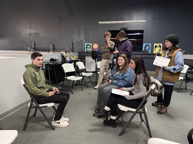 Group discussion in a bright meeting room at Recovery On The Harbor, a sober living home in Boston.