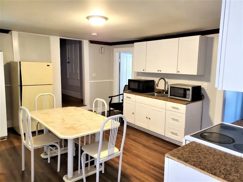 Bright kitchen with dining table at Men of Dignity - Southbridge Men's Sober House, a sober living home in Boston.