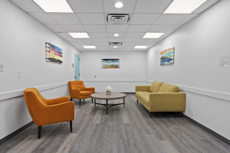 Bright sitting area with colorful chairs at On Call Treatment, a sober living home in Boston.