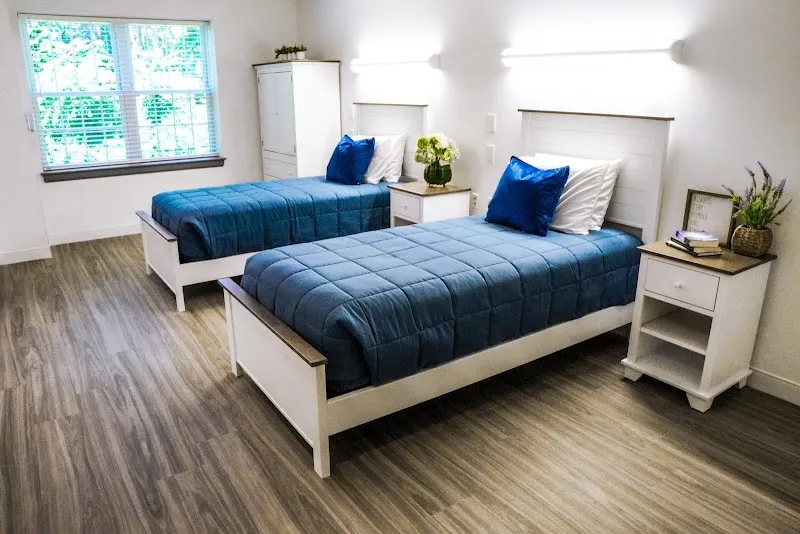 Cozy bedroom with two beds at Charles River Recovery LLC, a sober living home in Boston.