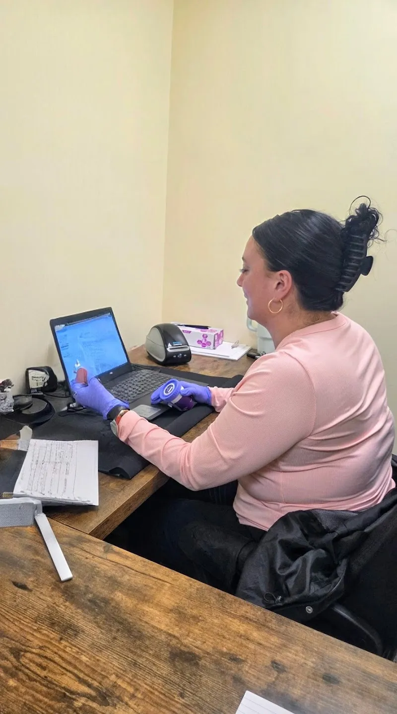 Professional staff member at Lion Heart Behavioral Health treatment center in Boston working at a desk with a laptop.