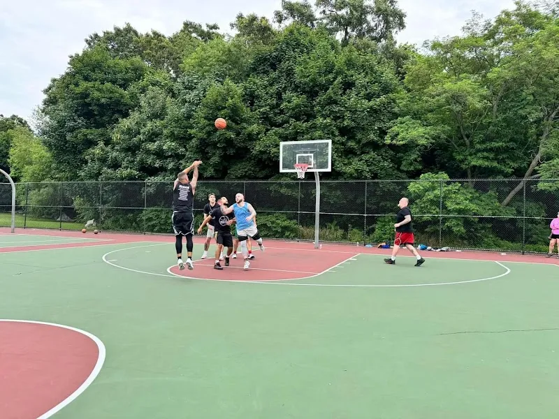 Outdoor basketball court with players at Aftermath Addiction Treatment Ctr LLC, a treatment center in Boston.